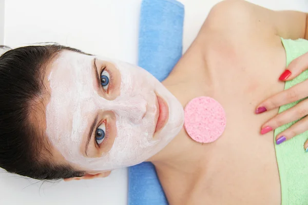 Beautiful young blue eye woman with clay facial mask — Stock Photo, Image