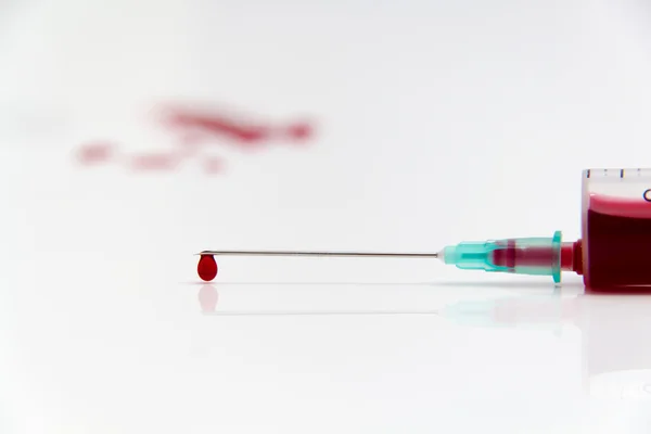 Syringe of Red Blood Test for research HIV AIDS Concept Idea — Stock Photo, Image