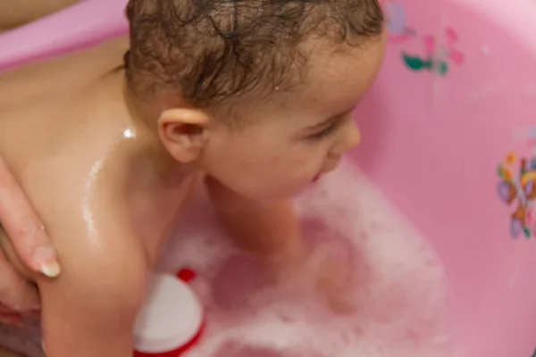 Cute little girl bathes in a shower — Stock Photo, Image