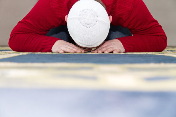 Young muslim man showing Islamic prayer