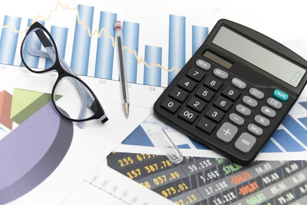 Businessman analyzing investment charts with calculator and lapt — Stock Photo, Image