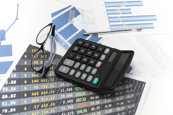 Businessman analyzing investment charts with calculator and lapt — Stock Photo, Image