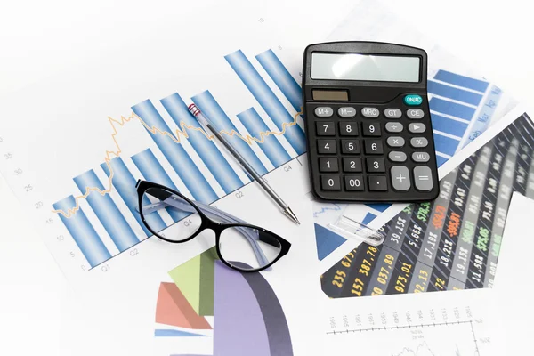 Businessman analyzing investment charts with calculator and lapt — Stock Photo, Image