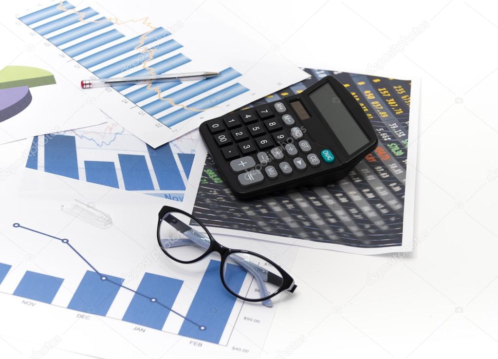 Businessman analyzing investment charts with calculator and lapt