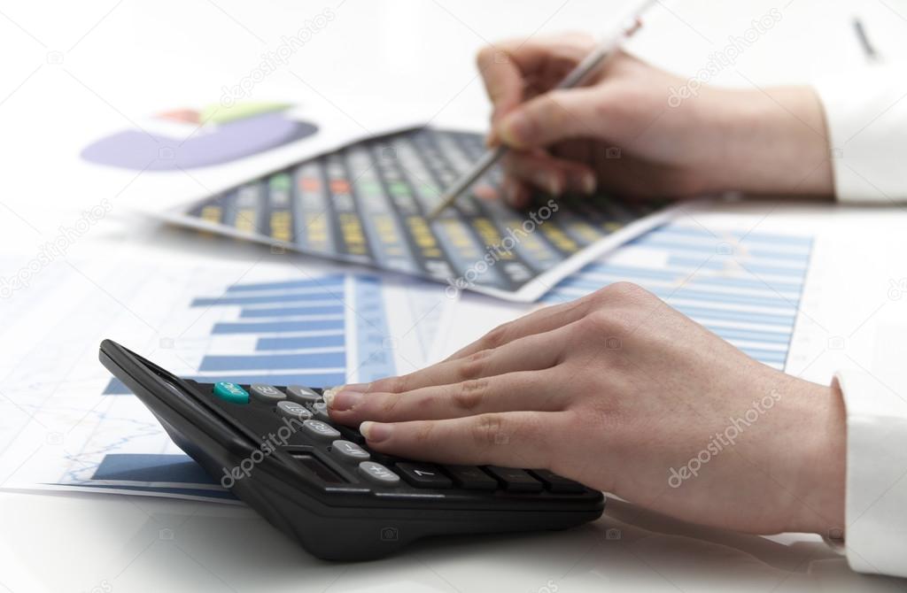 Young businesswoman calculating financial documents