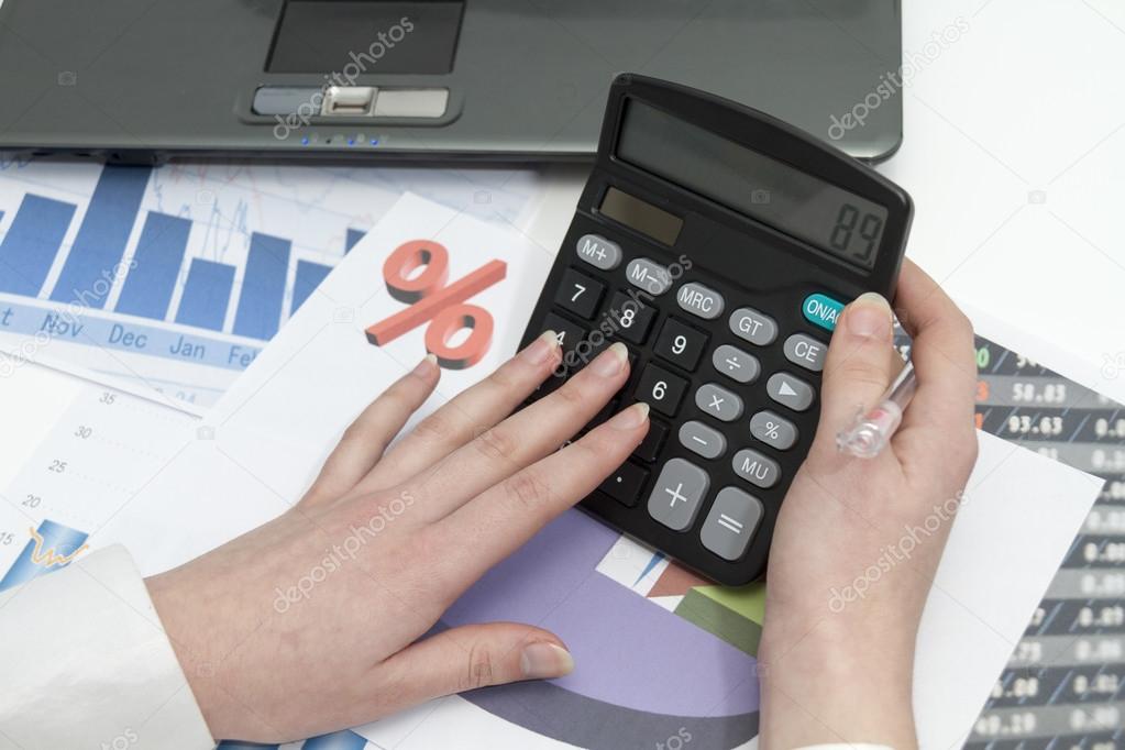 Young businesswoman calculating financial documents