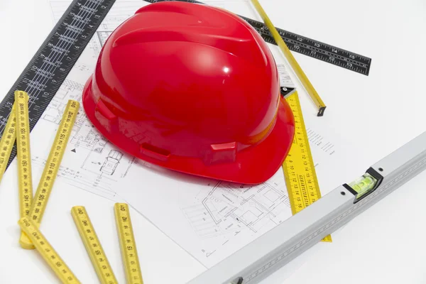 Helmet and tools for construction drawings and buildings — Stock Photo, Image