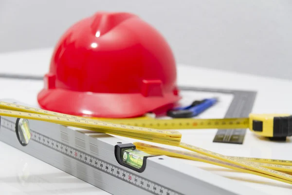 Helmet and tools for construction drawings and buildings — Stock Photo, Image