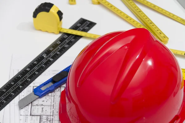 Helmet and tools for construction drawings and buildings — Stock Photo, Image