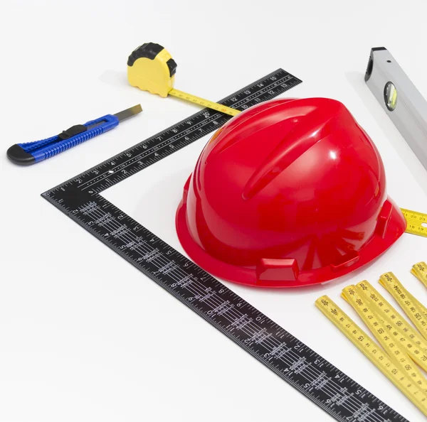 Helmet and tools for construction drawings and buildings — Stock Photo, Image