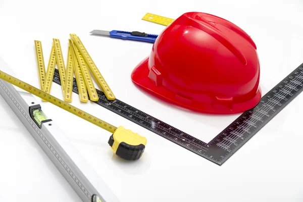 Helmet and tools for construction drawings and buildings — Stock Photo, Image