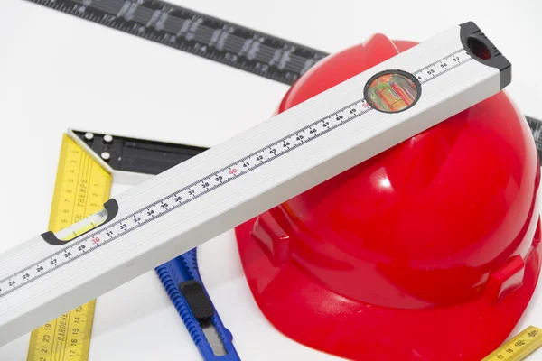 Helmet and tools for construction drawings and buildings — Stock Photo, Image