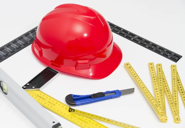 Helmet and tools for construction drawings and buildings — Stock Photo, Image