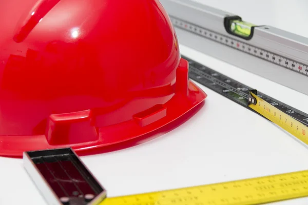 Helmet and tools for construction drawings and buildings — Stock Photo, Image