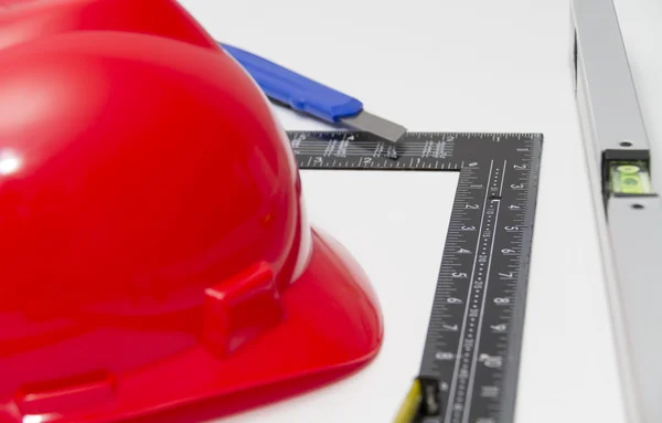 Helmet and tools for construction drawings and buildings — Stock Photo, Image