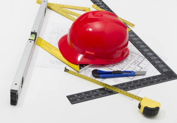 Helmet and tools for construction drawings and buildings — Stock Photo, Image