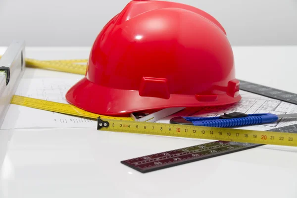 Helmet and tools for construction drawings and buildings — Stock Photo, Image