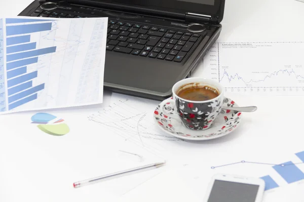 Businessman  with coffee and laptop analyzing of the  monitoring — Stock Photo, Image