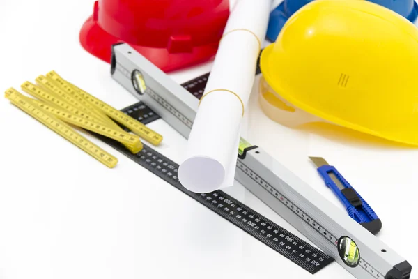 Colorful helmets and tools for construction drawings and buildin — Stock Photo, Image