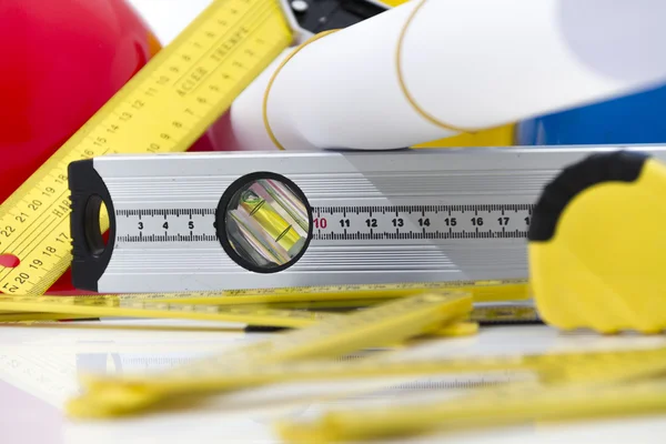 Colorful helmets and tools for construction drawings and buildin — Stock Photo, Image