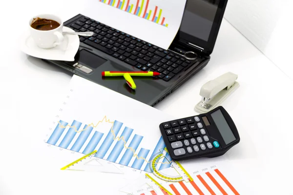 Analyzing business investment charts with calculator and laptop — Stock Photo, Image