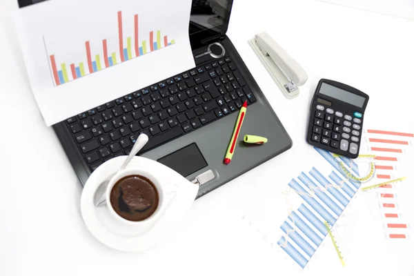 Analyzing business investment charts with calculator and laptop — Stock Photo, Image