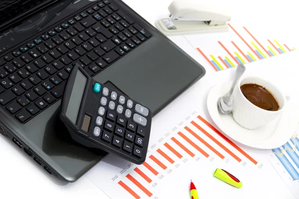 Analyzing business investment charts with calculator and laptop Royalty Free Stock Photos