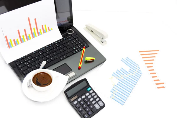 Analyzing business investment charts with calculator and laptop Royalty Free Stock Photos