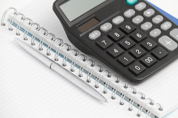 Business concept with calculator, pen and notebook — Stock Photo, Image