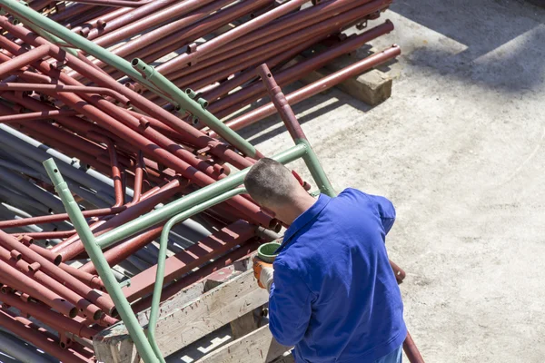 stock image Paint worker painting metal designs