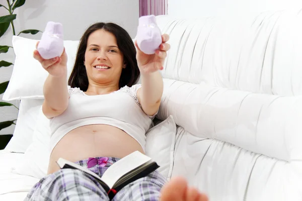 Terhes nő babacipővel — Stock Fotó