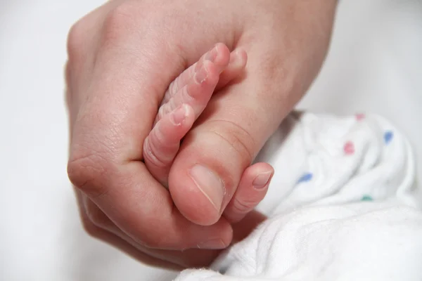 Baby hand holding motherfinger, new born baby — Stock Photo, Image