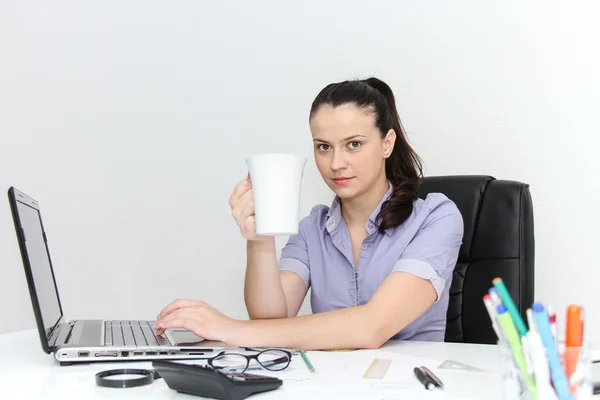 Young female designer working with architectural plan — Stock Photo, Image