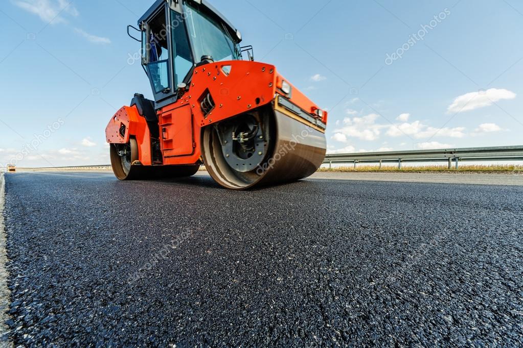 Asphalt road making construction site with heavy machines