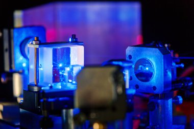 Blue laser in a quantum optics lab. clipart