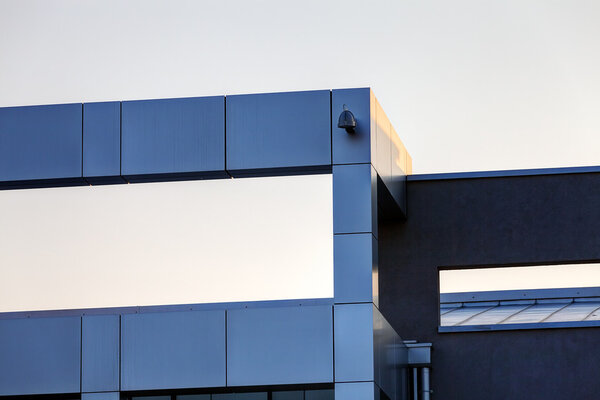 Details of gray facade made of aluminum panels on industrial building