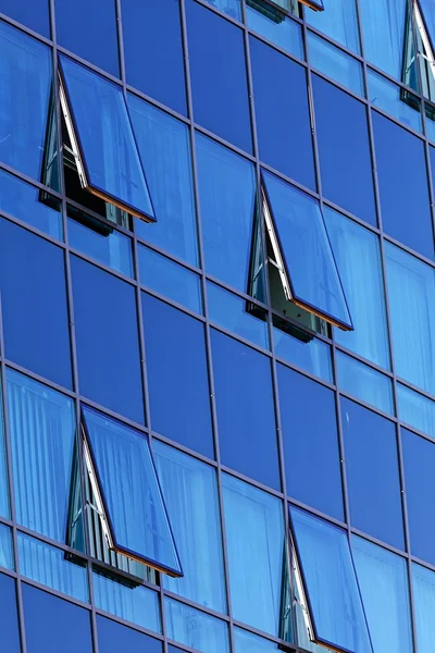 Glass facade with opened windows — Stock Photo, Image