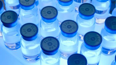 Bir grup aşı şişesi. Ampuller halinde ilaç. Laboratuvarda sıvı örnekleri için cam şişeler..
