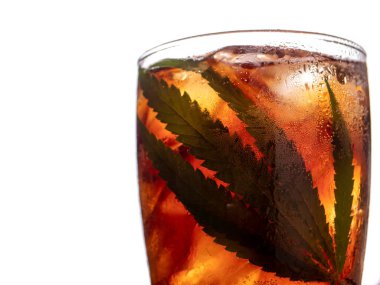 Glass of cola with ice cubes and cannabis leaf on white background. clipart