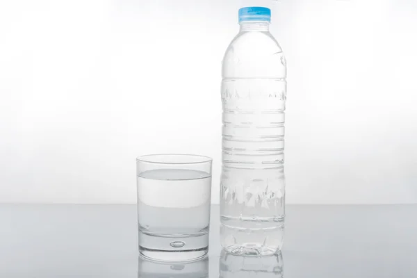 Water in plastic bottle with glass — Stock Photo, Image