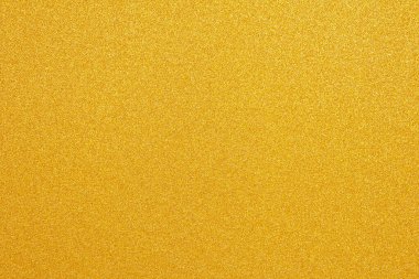 Parlak sarı yaprak. Altın rengi parıltı dokusu. Noel soyut arkaplanı, odaklanmamış.