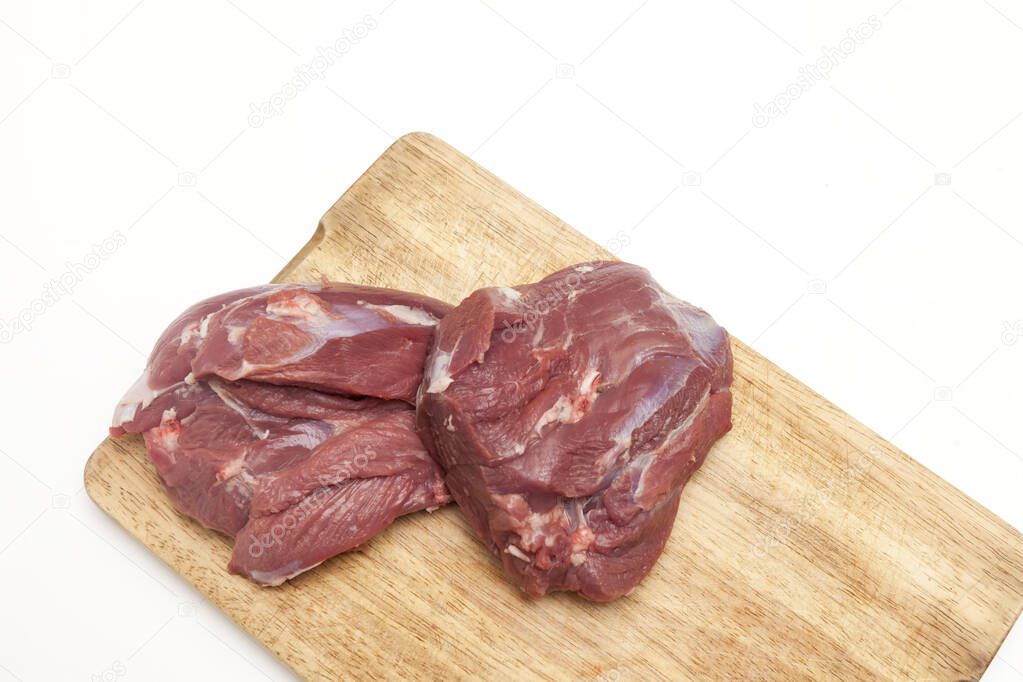 Fresh raw lamb meat on wooden cutting board, close-up, top view, copy space. Dieting product.