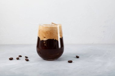 Iced Coffee with coconut milk on light table. Selective focus, copy space.