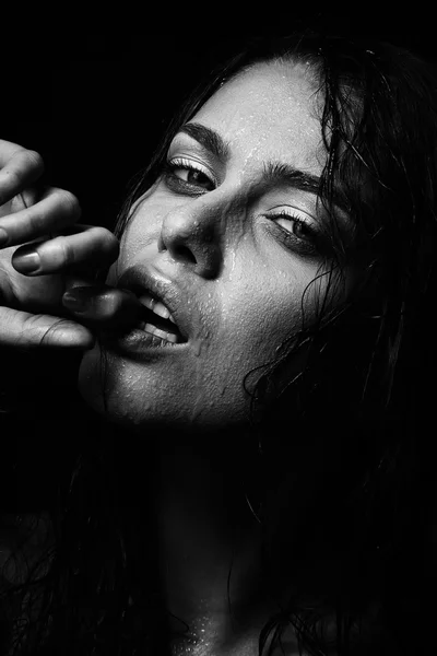 Wet woman portrait with water drops on the face. Black and white