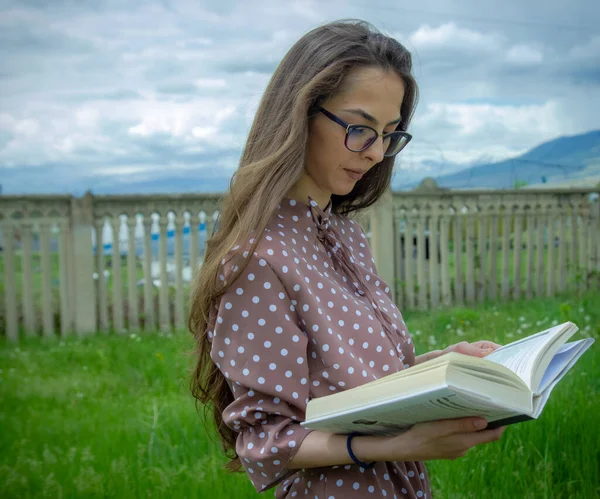 pretty woman with book, woman reading a book outdoors