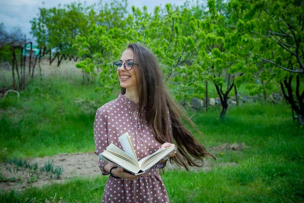 pretty woman with book, woman reading a book outdoors