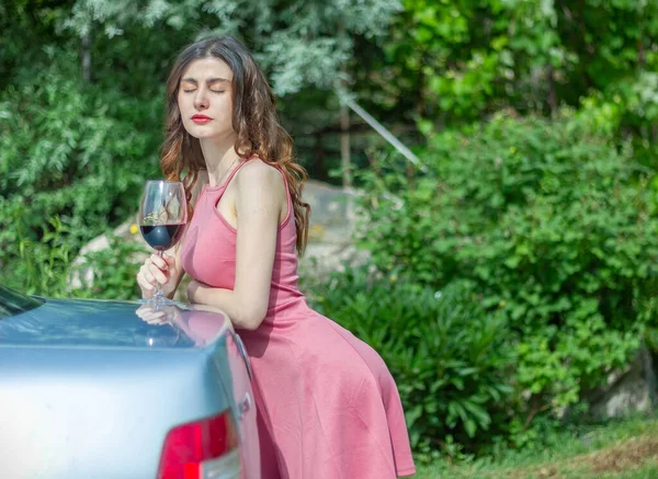 woman with wine, woman with glass of wine, woman drinking red wine in the garden