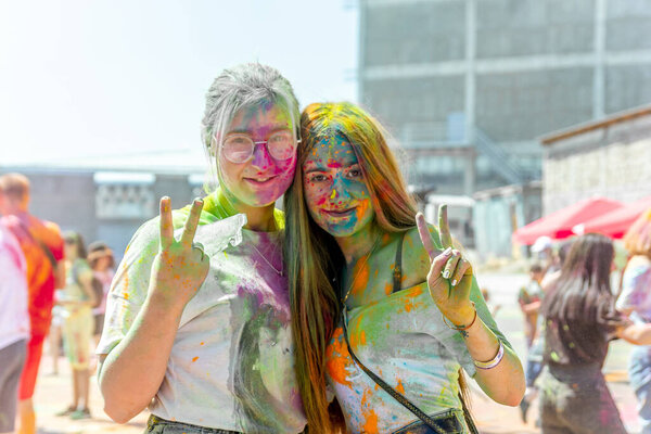 the pretty young womans in the color fest, colored face of the young womans, color festival in india