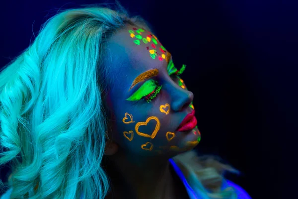 portrait of a woman with painted face, woman with uv makeup in studio, portrait of a woman in carnival mask, the woman is decorated in a ultraviolet powder