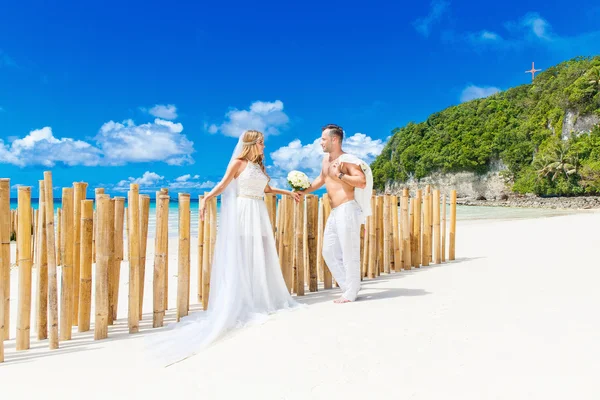 Beautiful blond bride in white wedding dress with big long white — Stock Photo, Image